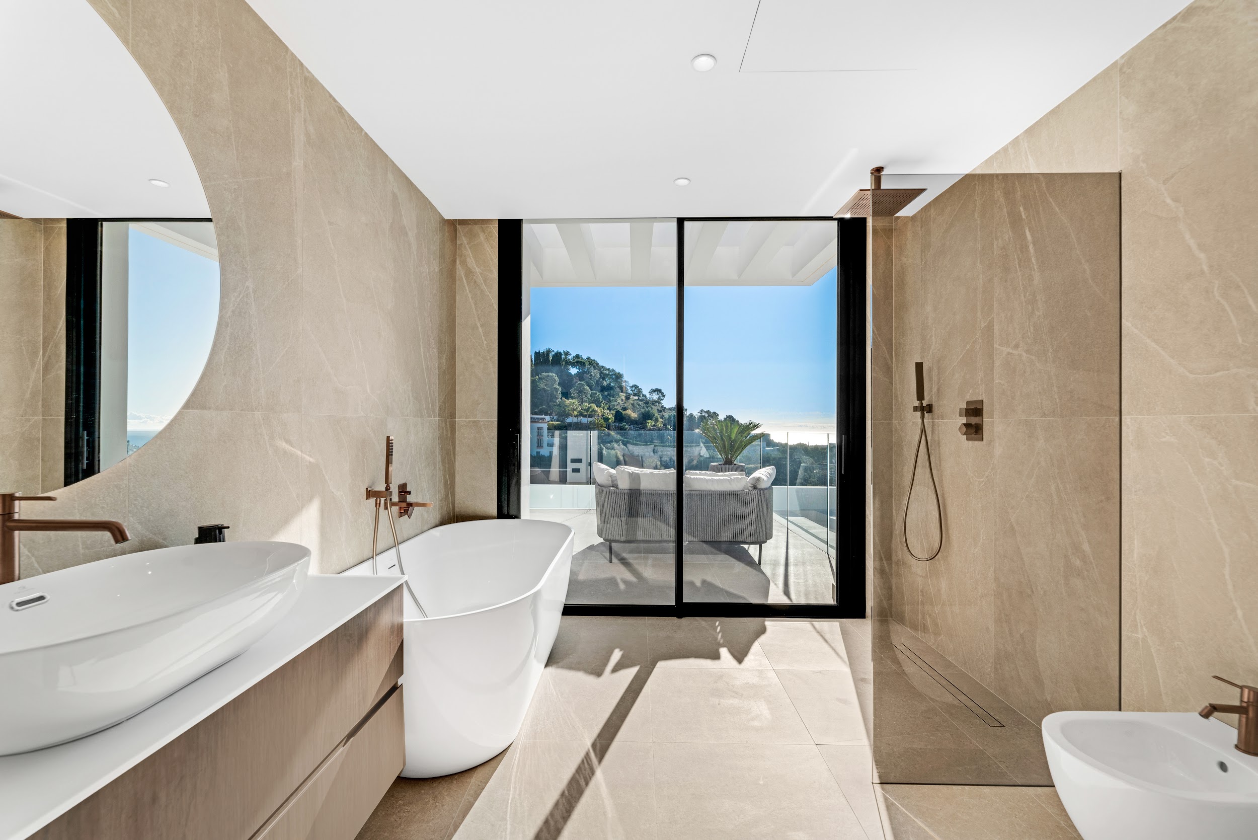 Bathroom with freestanding bath and sea views