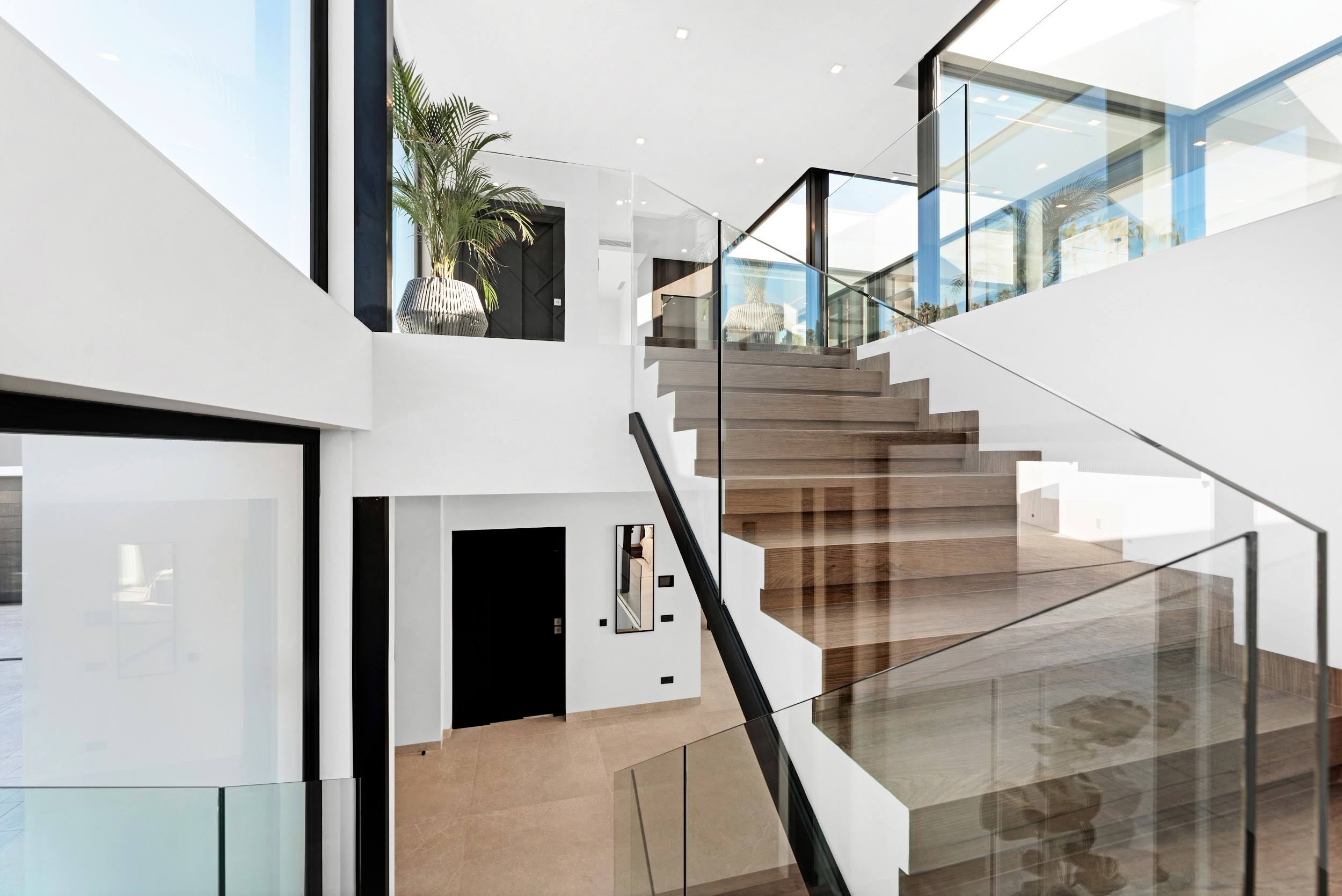 Floating staircase with tropical courtyard
